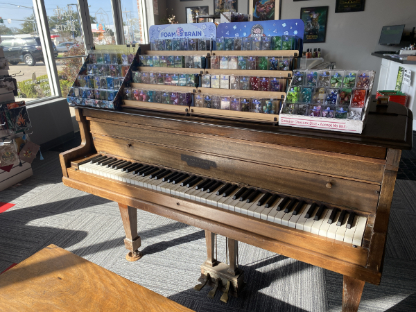 a game store piano (Little Wars, Baton Rouge) festooned with dice